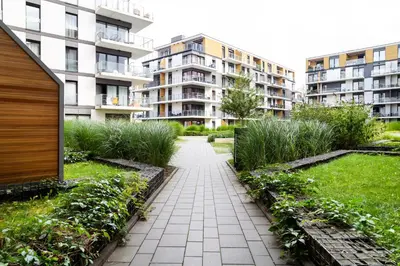a garden with a walkway in front of buildings at Househost Apt - Rakowicka 20H in Kraków