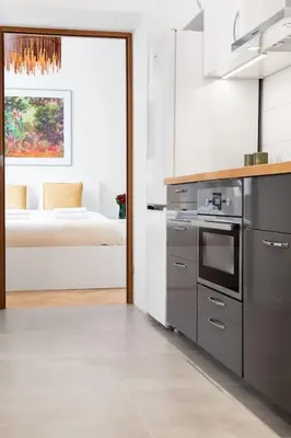 a kitchen with a stove top oven next to a window at Househost Apt - Krowoderska 55 in Kraków