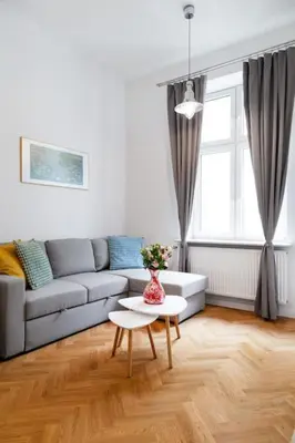 a living room with a couch and a table at Househost Apt - Krowoderska 55 in Kraków