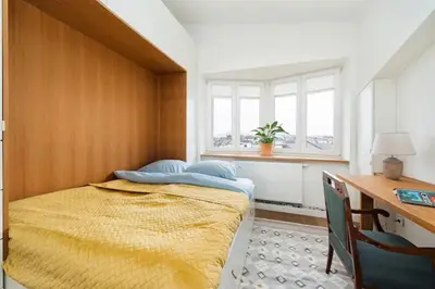 a bedroom with a bed and a desk and window at Heart of Cracow - AC - Retoryka 24 in Kraków