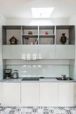 a white kitchen with white cabinets and a sink at Heart of Cracow - AC - Retoryka 24 in Kraków