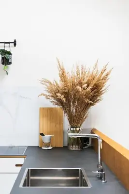a kitchen counter with a sink and some plants at Penthouse - Heart of Cracow - Balcony - AC in Kraków