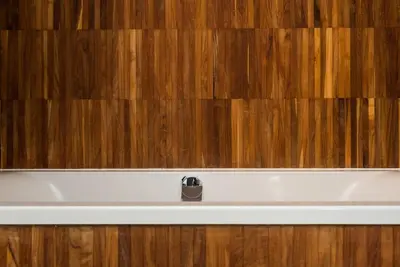 a white bath tub sitting next to a wooden wall at Penthouse - Heart of Cracow - Balcony - AC in Kraków