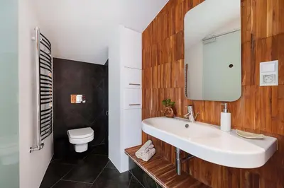 a bathroom with a white sink and a toilet at Penthouse - Heart of Cracow - Balcony - AC in Kraków