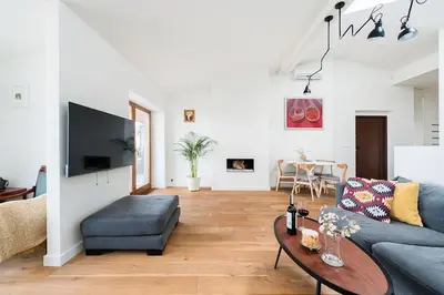 a living room with a couch and a table at Penthouse - Heart of Cracow - Balcony - AC in Kraków