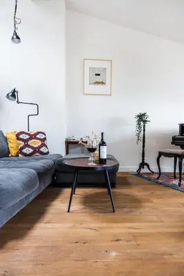a living room with a couch and a table at Penthouse - Heart of Cracow - Balcony - AC in Kraków