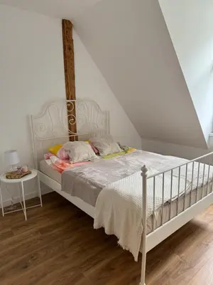a bedroom with a bed with a white bed frame at Apartament 2 Willa Bellevue in Rabka-Zdroj