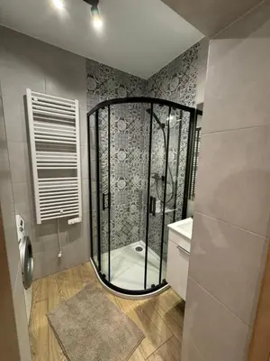 a bathroom with a shower with a glass door at Apartament 2 Willa Bellevue in Rabka-Zdroj