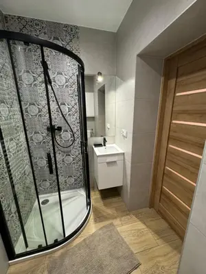 a small bathroom with a shower and a sink at Apartament 2 Willa Bellevue in Rabka-Zdroj