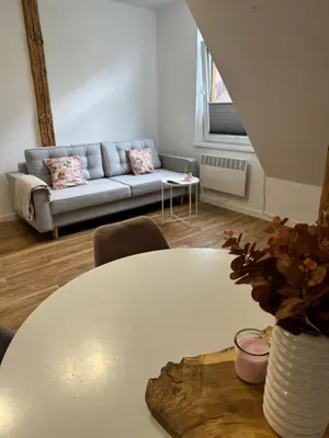 a living room with a white table and a couch at Apartament 2 Willa Bellevue in Rabka-Zdroj