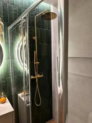 a shower with a shower head in a bathroom at Apartament Widna 3 in Kraków