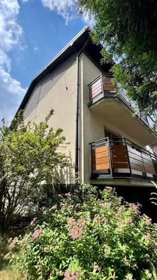 a building with balconies and flowers in front of it at Apartament Widna 3 in Kraków