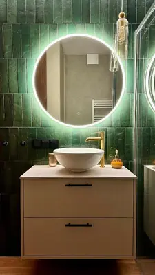 a bathroom with a sink and a mirror at Apartament Widna 3 in Kraków