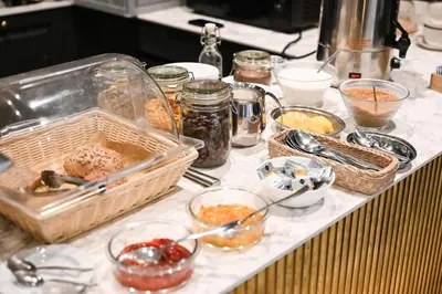 a counter with many bowls of food on it at Dom Gościnny Uniwersytetu Jagiellońskiego in Kraków