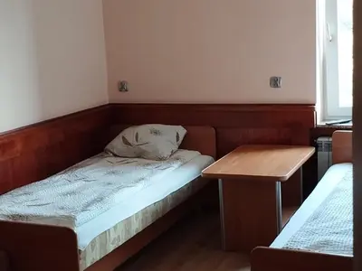 a small room with a bed and a table at Karpiówka noclegi in Osiek