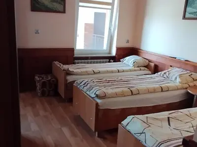 three beds in a room with a window at Karpiówka noclegi in Osiek