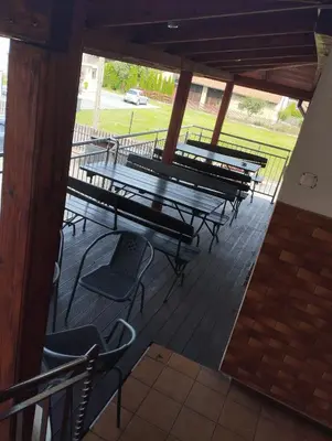 a group of picnic tables and chairs on a patio at Karpiówka noclegi in Osiek