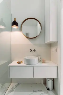 a white bathroom with a sink and a mirror at Rzeszowska 5 Apt 7 Stylowy pobyt in Kraków