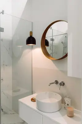 a white bathroom with a sink and a mirror at Rzeszowska 5 Apt 7 Stylowy pobyt in Kraków