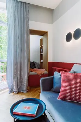 a living room with a blue couch and a table at Rzeszowska 5 Apt 7 Stylowy pobyt in Kraków