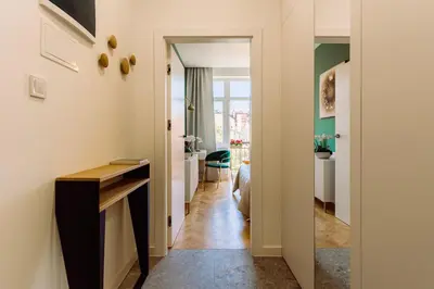 a hallway leading to a bedroom with a desk and a room at Rzeszowska 5 Apt 12 Stylowy pobyt in Kraków
