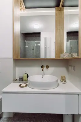 a white bathroom with a sink and a mirror at Rzeszowska 5 Apt 12 Stylowy pobyt in Kraków