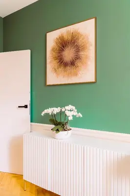 a vase with flowers on a table in a room at Rzeszowska 5 Apt 12 Stylowy pobyt in Kraków