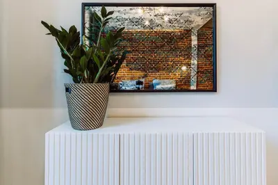 a plant in a vase sitting on top of a table at Rzeszowska 5 Apt 12 Stylowy pobyt in Kraków