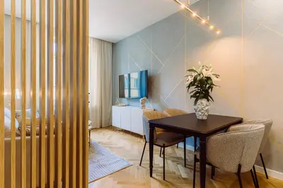 a dining room with a table and chairs at Rzeszowska 5 Apt 12 Stylowy pobyt in Kraków
