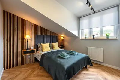 a bedroom with a bed and a large window at Sunflower Apartment Kalwaryjska Street in Kraków