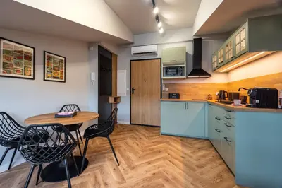 a kitchen with a table and chairs in a room at Sunflower Apartment Kalwaryjska Street in Kraków
