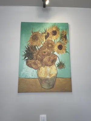 a painting of a vase with sunflowers in it at Sunflower Apartment Kalwaryjska Street in Kraków
