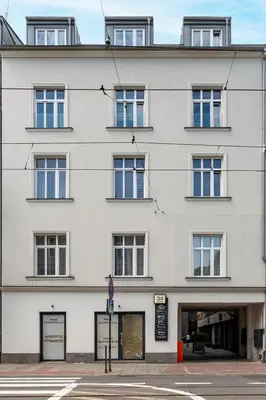 a white building with many windows on a street at Sunflower Apartment Kalwaryjska Street in Kraków