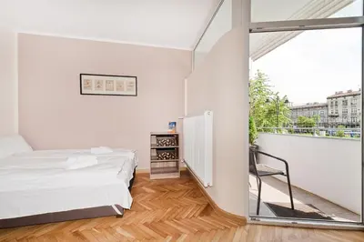 a bedroom with a bed and a balcony at Dietla Old Town, Sun & Snow in Kraków