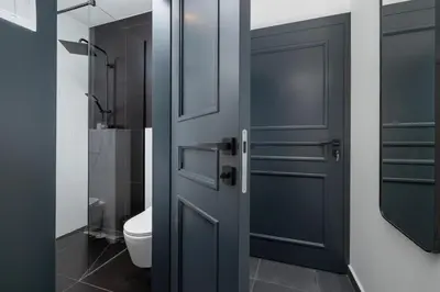 a bathroom with a blue door and a toilet at Studio apartment - Starowiślna 69 street in Kraków
