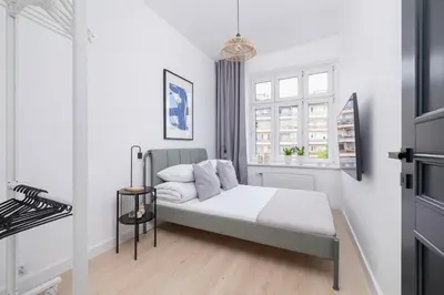 a small bedroom with a bed and a window at 2-bedroom apartment - Starowiślna 69 street in Kraków