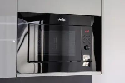 a microwave oven with aania written on it at 2-bedroom apartment - Starowiślna 69 street in Kraków