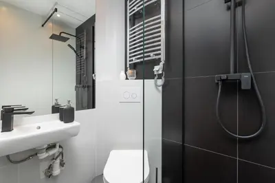 a bathroom with a shower and a toilet and a sink at 2-bedroom apartment - Starowiślna 69 street in Kraków