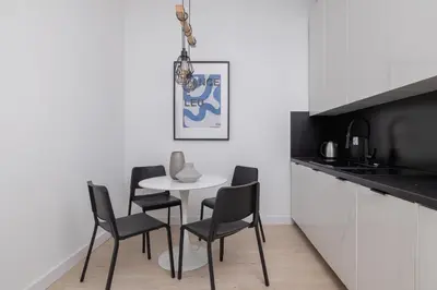 a dining room with a table and chairs in a kitchen at 2-bedroom apartment - Starowiślna 69 street in Kraków