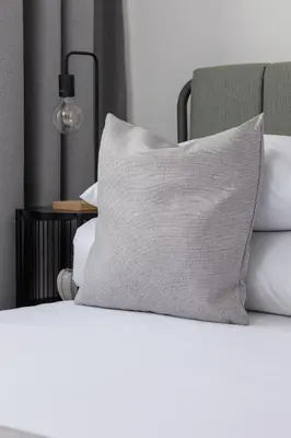 a pillow sitting on top of a bed at 2-bedroom apartment - Starowiślna 69 street in Kraków