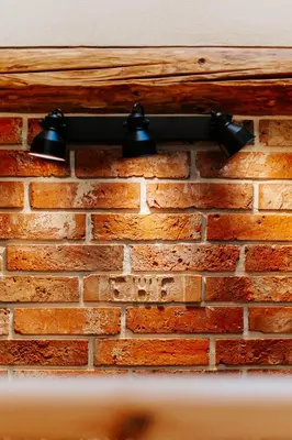 a brick wall with two lights on it at JÓZEFÓWKA Stara Stodoła in Zagórze