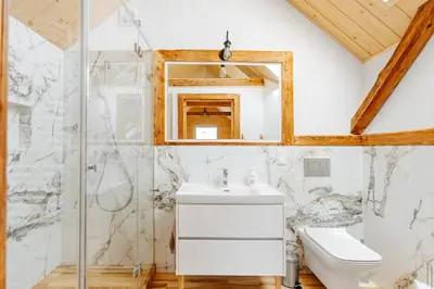 a bathroom with a sink and a mirror at JÓZEFÓWKA Stara Stodoła in Zagórze