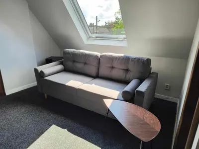 a living room with a couch and a window at Dom na wsi w okolicy ENERGYLANDIA ZATOR in Łączany