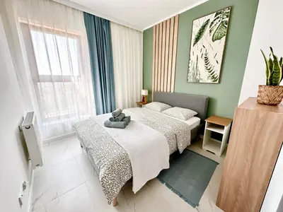 a bedroom with a bed with a teddy bear on it at Vidok Residence Apartments in Młoszowa