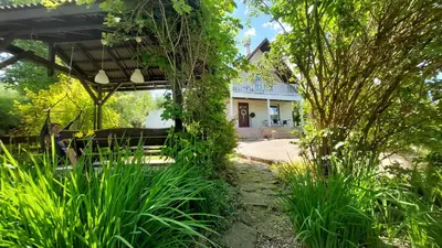 a garden with a bench in front of a house at Cottage Zawoja z Jacuzzi in Zawoja