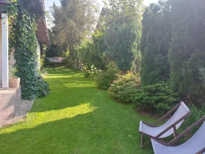 a garden with a bench on the grass at Cottage Zawoja z Jacuzzi in Zawoja