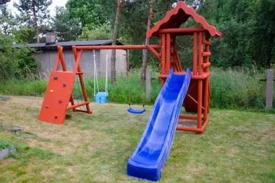 a playground with a slide and a slide at Noclegi Przy Starej Stodole in Jankowice