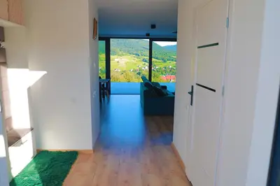 a living room with a couch and a table with chairs at Beskid Island in Dobra