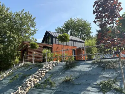 a house on a hill with a driveway at Domek Stróski in Wola Stróska