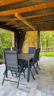 a wooden table and chairs on a patio at Domek Stróski in Wola Stróska